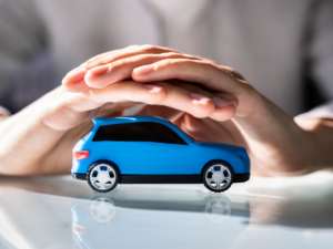two hands holding a floating blue toy car.